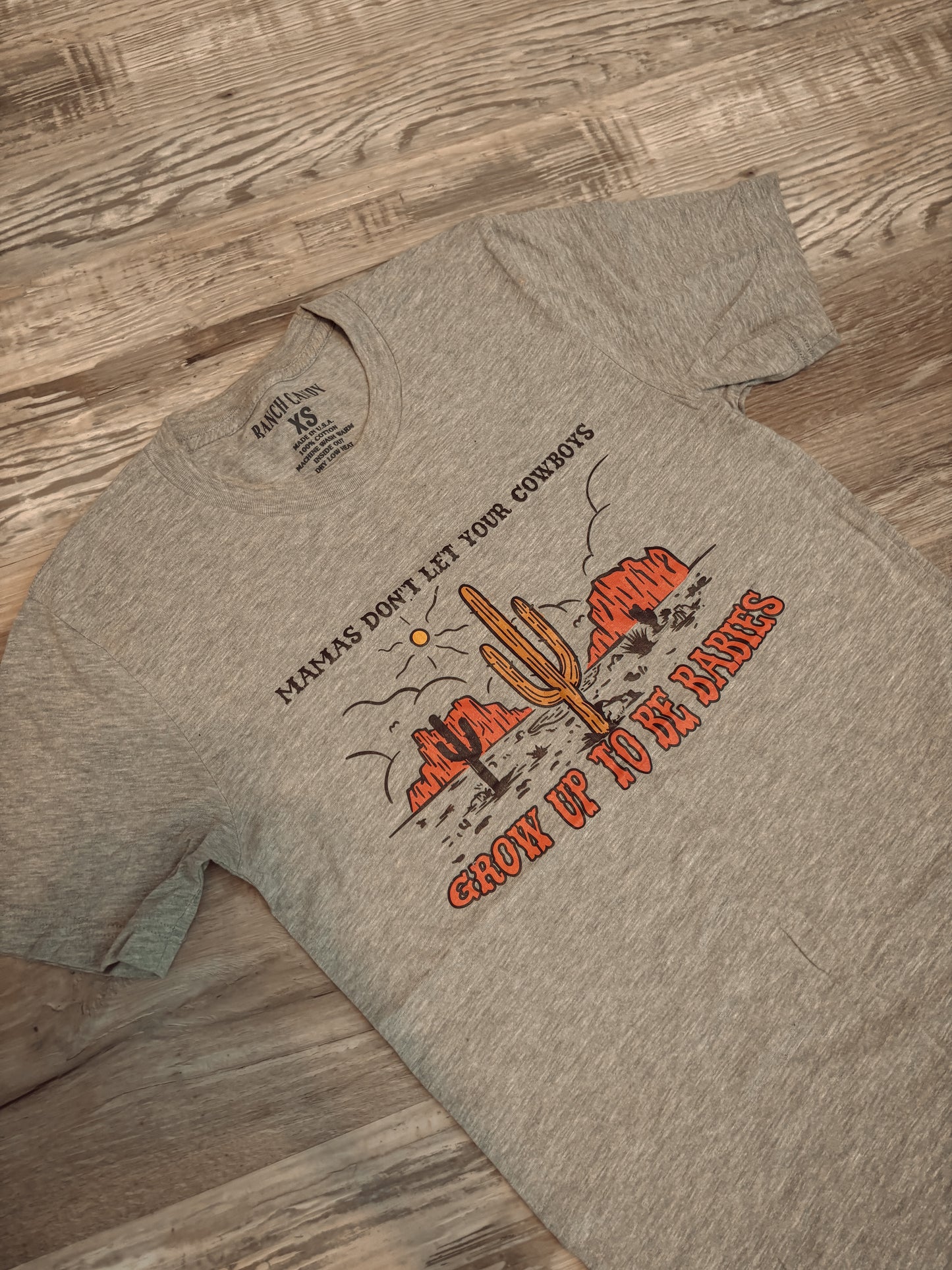 MAMAS DONT LET YOUR COWBOYS GROW UP TO BE BABIES GRAPHIC TEE